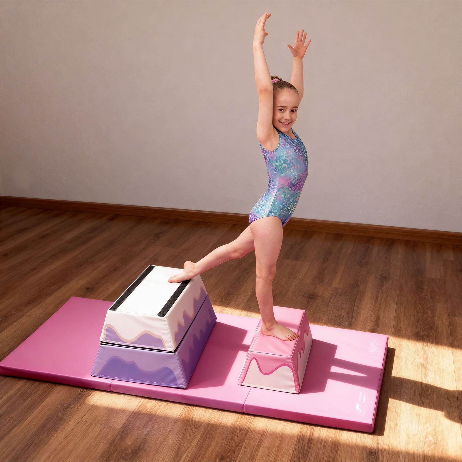 Young girl in a colorful leotard practicing on a 3-Layer Cake Themed Foam Vaulting Box in a home setting.