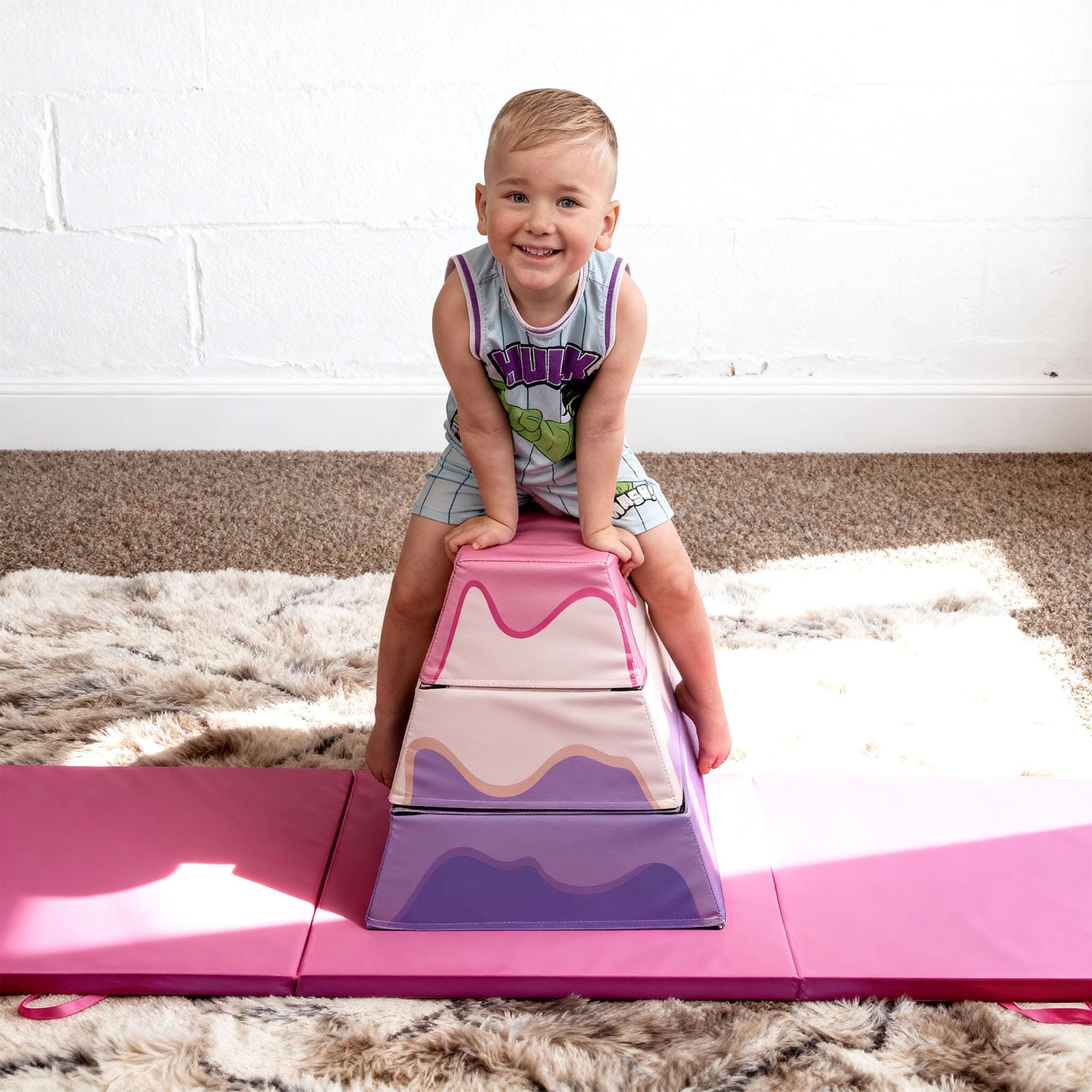 Child playing on a pink and purple 3-Layer Cake Themed Foam Vaulting Box