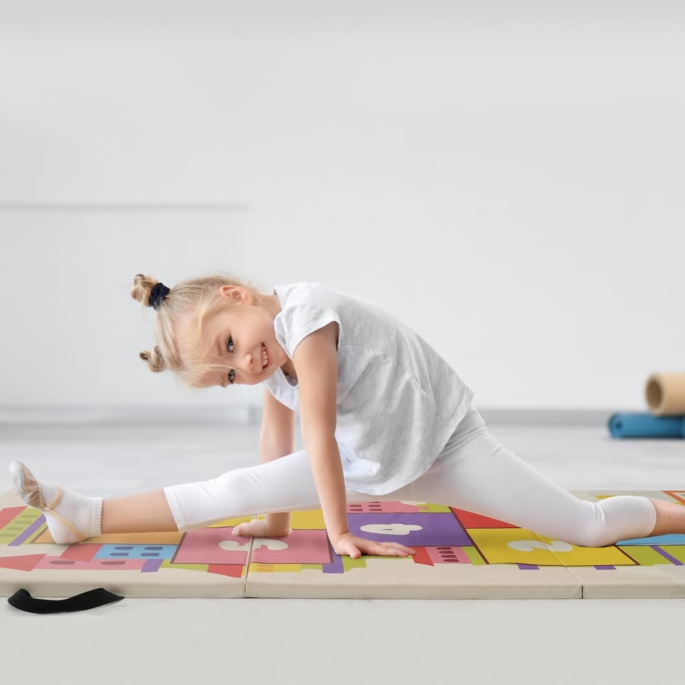 Kids practicing gymnastics at home using Kangaroo Hoppers tumbling mat