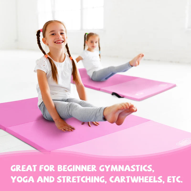 Two girls practicing gymnastics on pink folding exercise mats in bright studio