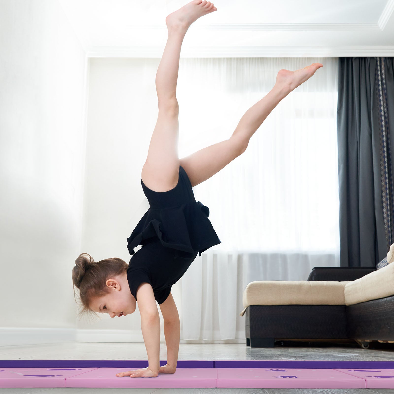Child playing and practicing on gymnastics mat and balance beam