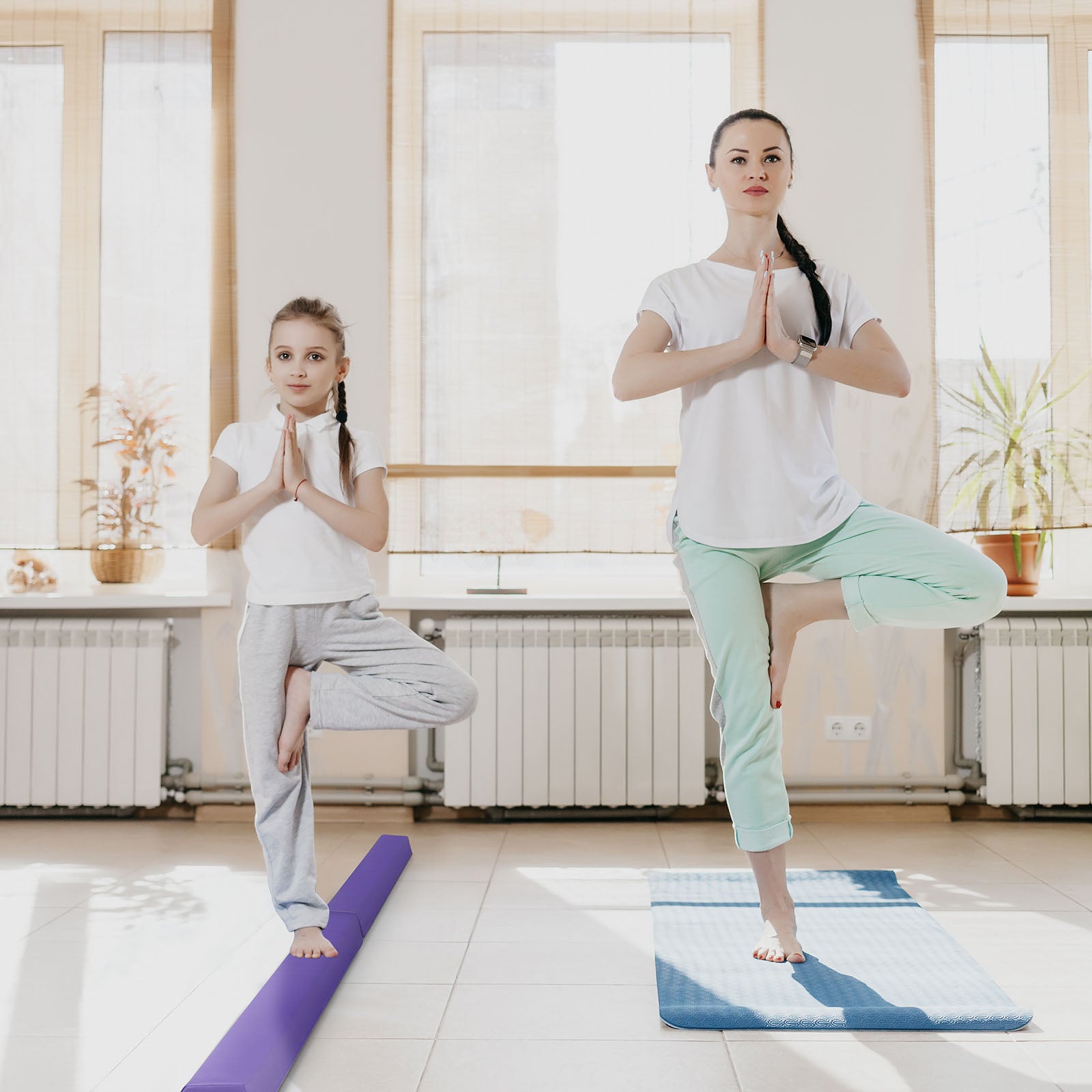Child playing and practicing on gymnastics mat and balance beam