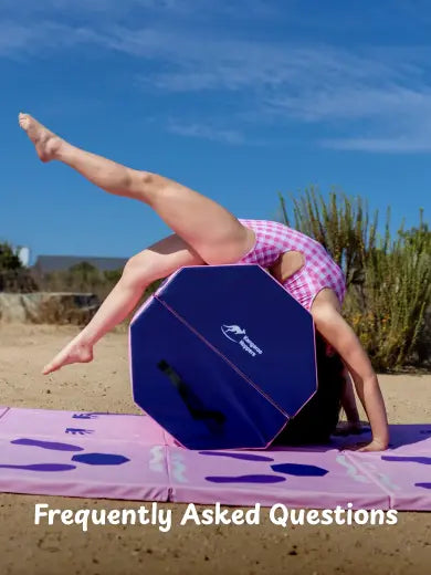 Gymnast performing backbend on blue octagonal tumble track mat outdoors