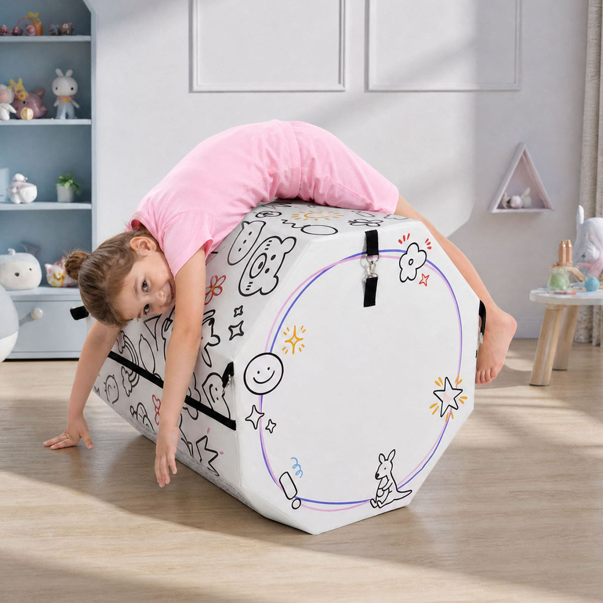 Child climbing white Kangaroo Hoppers Octagon Trainer Mat with colorful doodle design in playroom