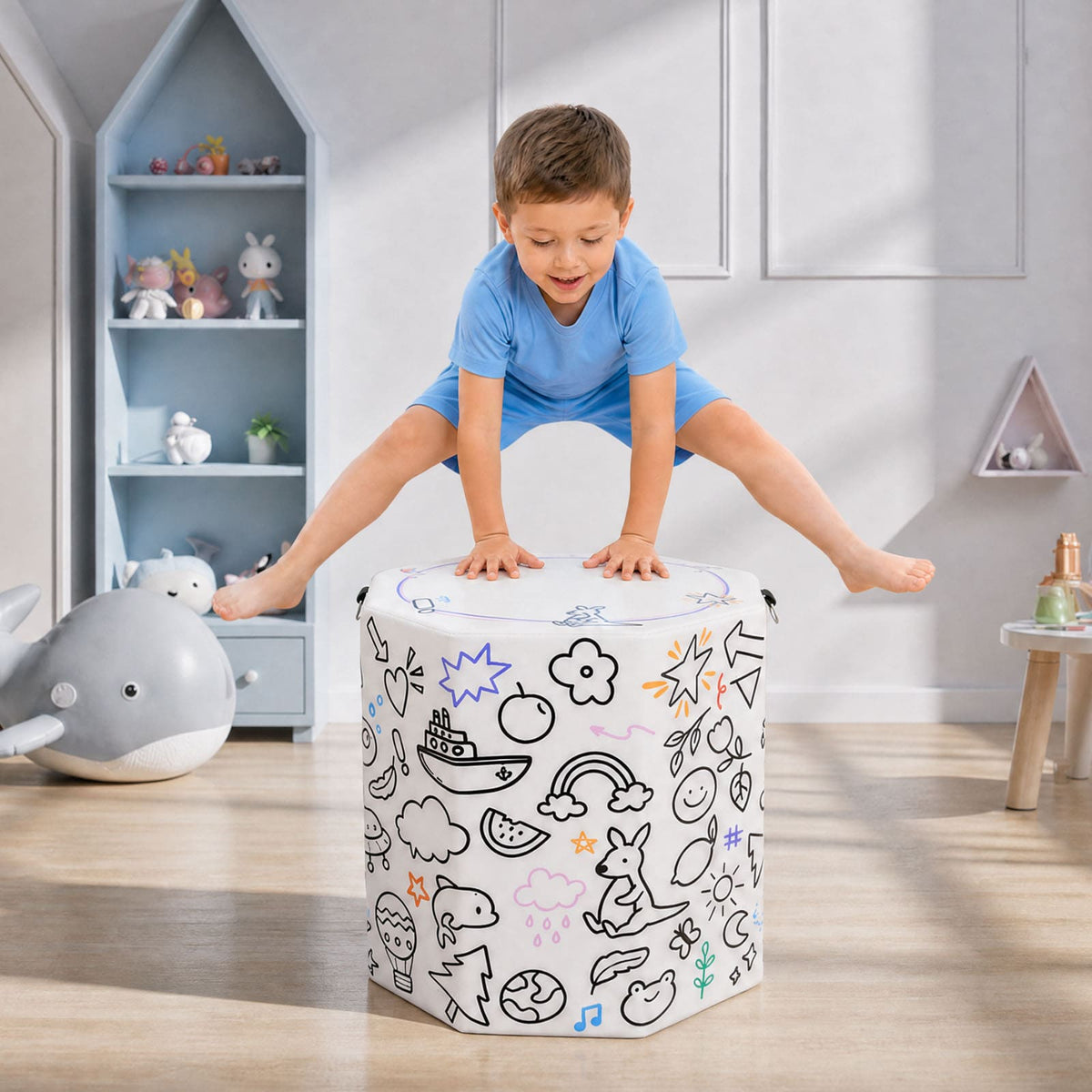 Boy jumping on white Kangaroo Hoppers Octagon Trainer Mat with colorful doodle designs in playroom