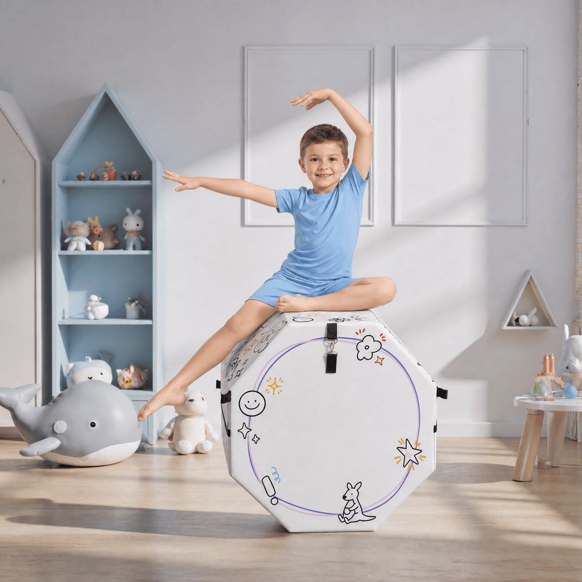 Boy sitting on white Kangaroo Hoppers Octagon Trainer Mat with black doodle designs in playroom