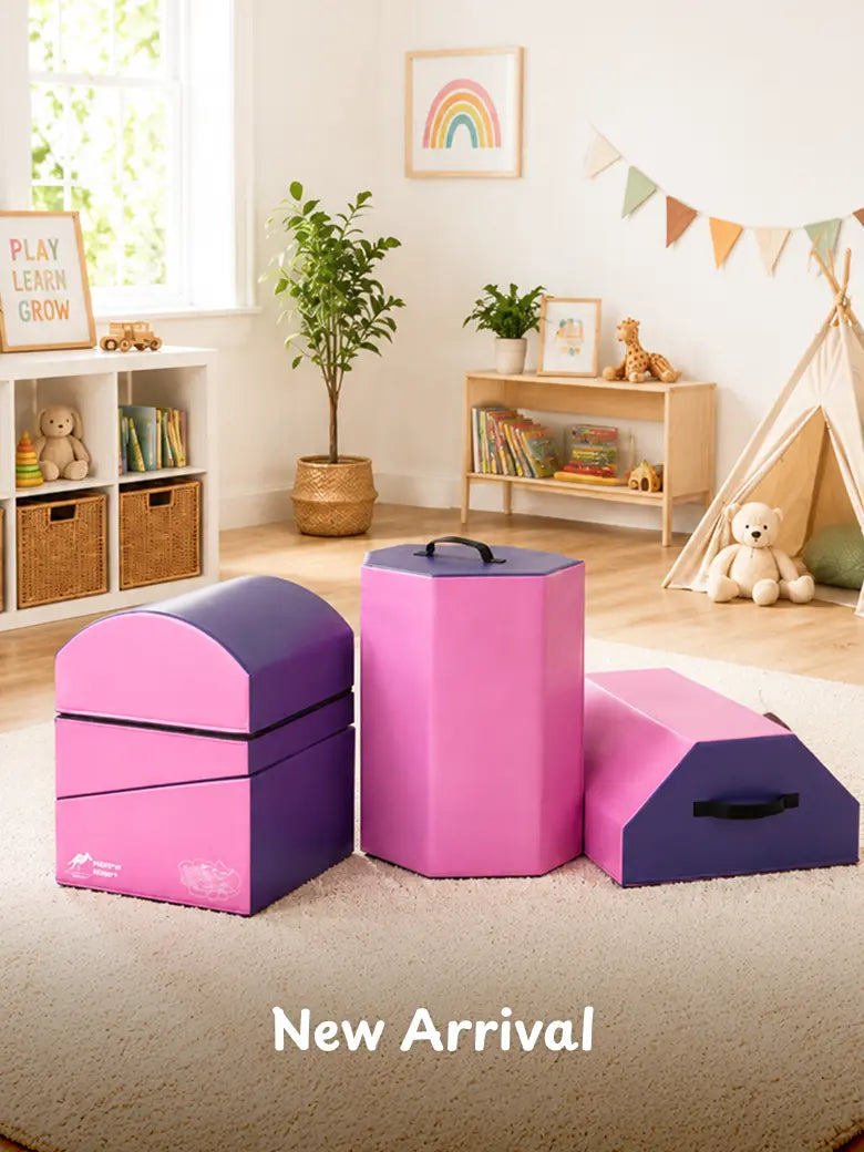 Pink and purple foam play blocks arranged on rug in bright playroom
