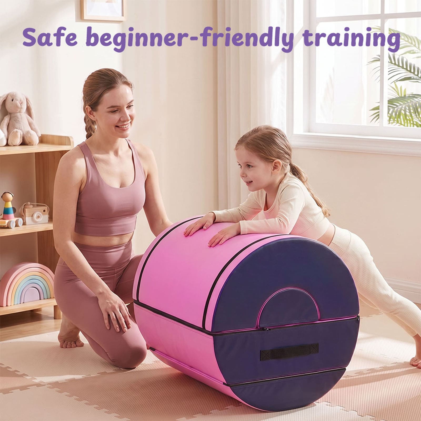A woman and a young girl are using a pink and purple foam exercise wheel in a bright, child-friendly room. Purple text at the top reads 'Safe beginner-friendly training'.